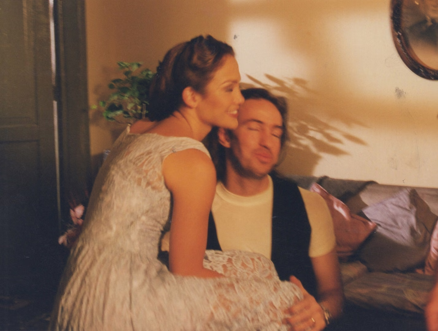 Jennifer López abraza a Benny Corral, sentados en un set